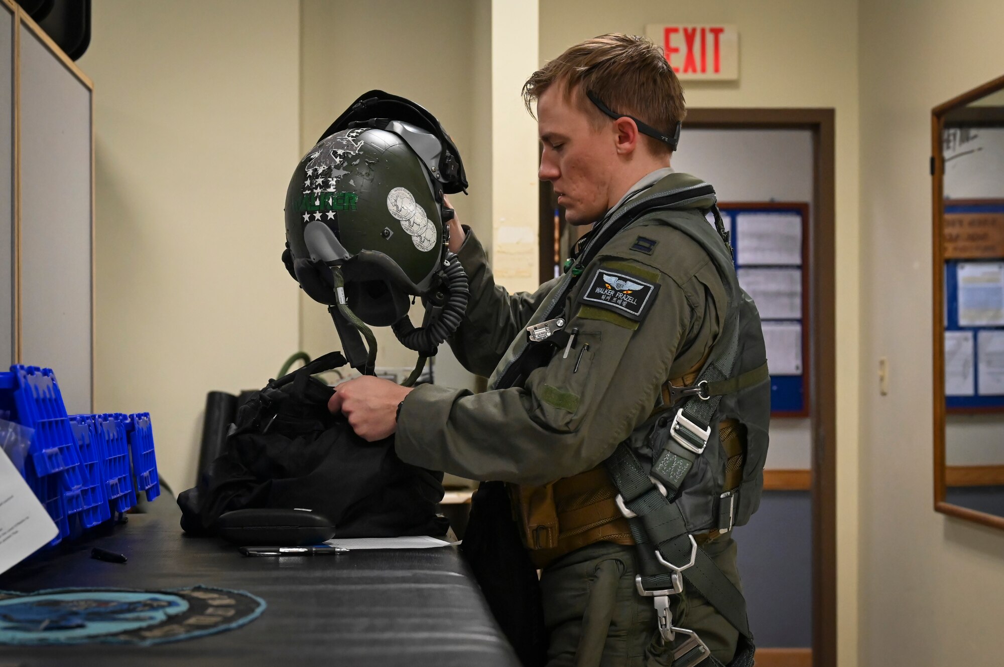 U.S. Air Force Capt. Walker Frazell, 35th Fighter Squadron F-16 Fighting Falcon pilot, prepares his aircrew flight equipment (AFE) in advance of conducting a training mission.