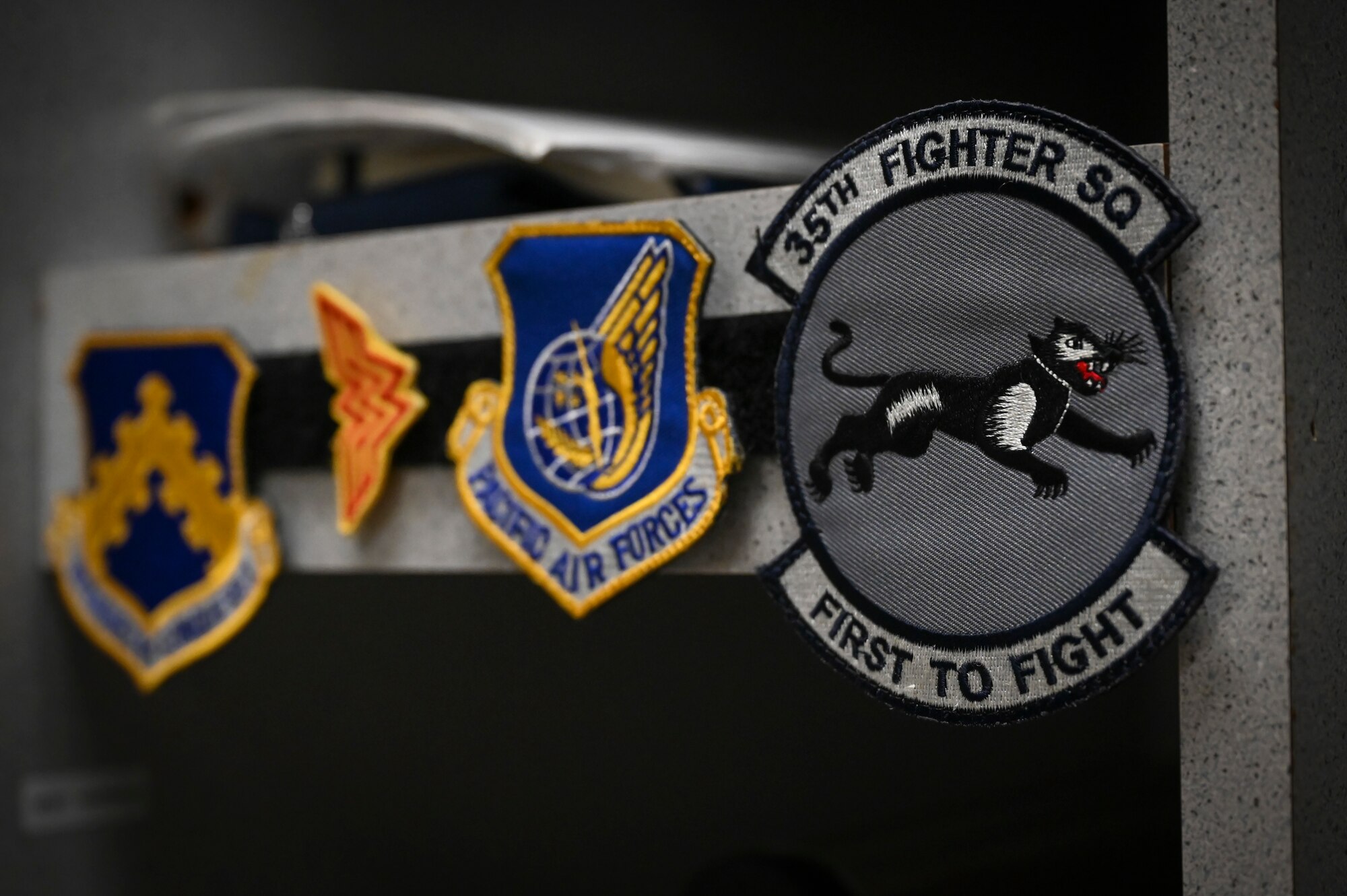 A 35th Fighter Squadron patch is displayed in an aircrew flight equipment locker.