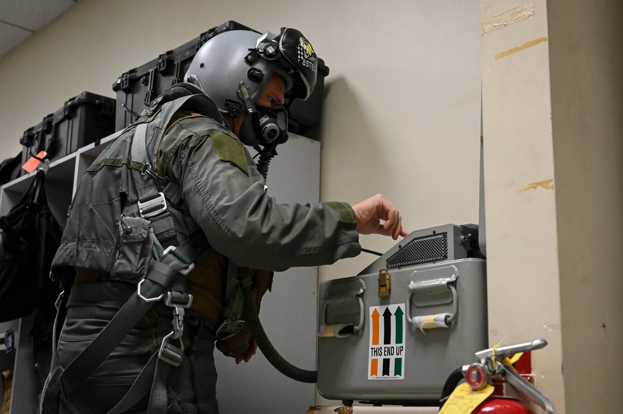 U.S. Air Force Lt. Col. James Divine, 8th Operations Group deputy commander and F-16 Fighting Falcon pilot, prepares his aircrew flight equipment (AFE) in advance of conducting a training mission.