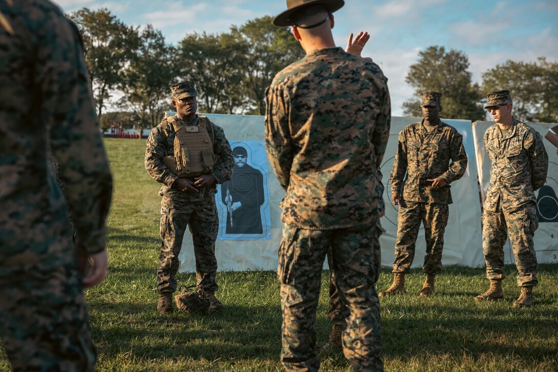 U.S. Marine Corps Brig. Gen. Anthony Henderson, commanding general of Training Command, listens to a range brief before he participates in different rifle drills at Weapons Training Battalion on Marine Corps Base Quantico, Virginia, Sept. 5, 2024. Training Command develops, sustains, and enhances individual military knowledge, skills, and attitudes in Marines to meet warfighting requirements of the total force. (U.S. Marine Corps photo by Lance Cpl. Ethan Miller)