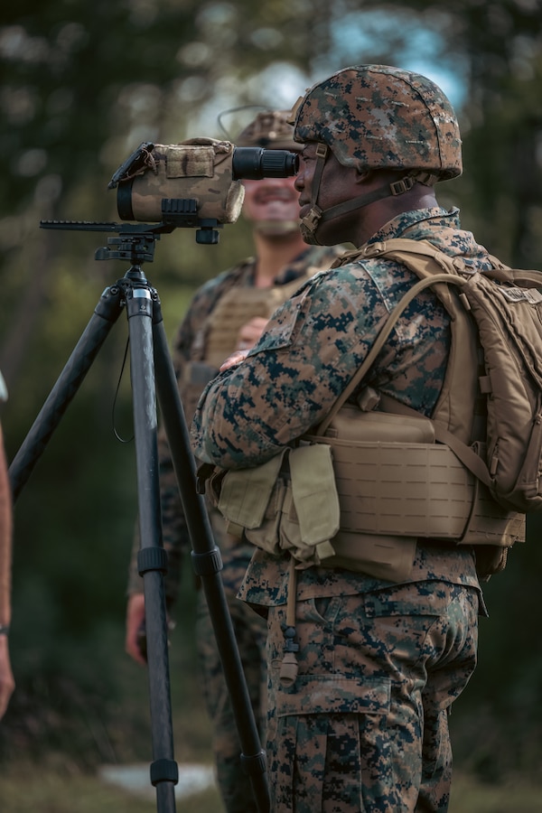 U.S. Marine Corps Brig. Gen. Anthony Henderson, commanding general of Training Command, looks through a range finder while participating in various rifle drills at Weapons Training Battalion on Marine Corps Base Quantico, Virginia, Sept. 5, 2024. Training Command develops, sustains, and enhances individual military knowledge, skills, and attitudes in Marines to meet warfighting requirements of the total force. (U.S. Marine Corps photo by Lance Cpl. Ethan Miller)