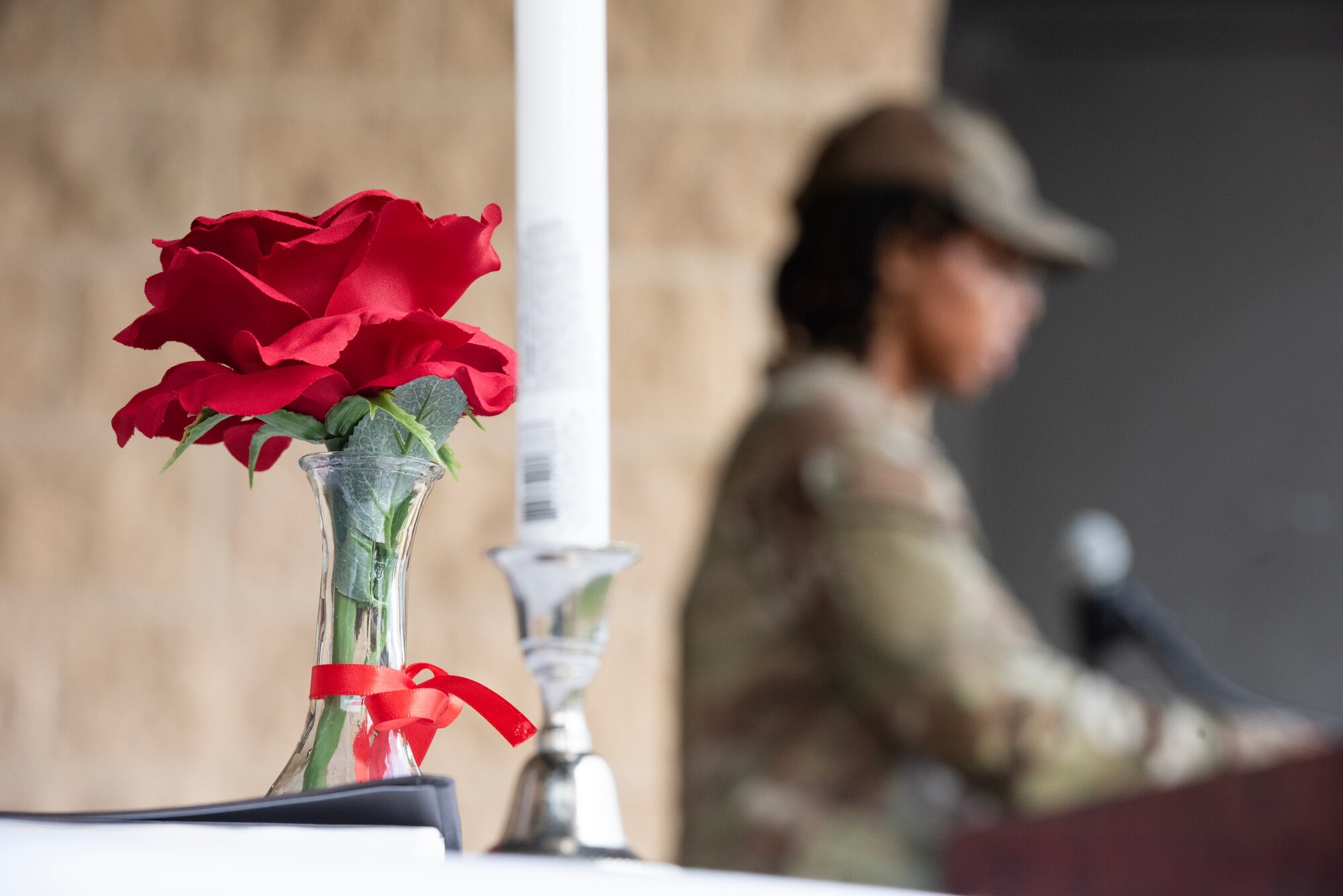 A single red rose in a vase sits on a table set with a white tablecloth during a 24-hour vigil commemorating National POW/MIA Recognition Day.
