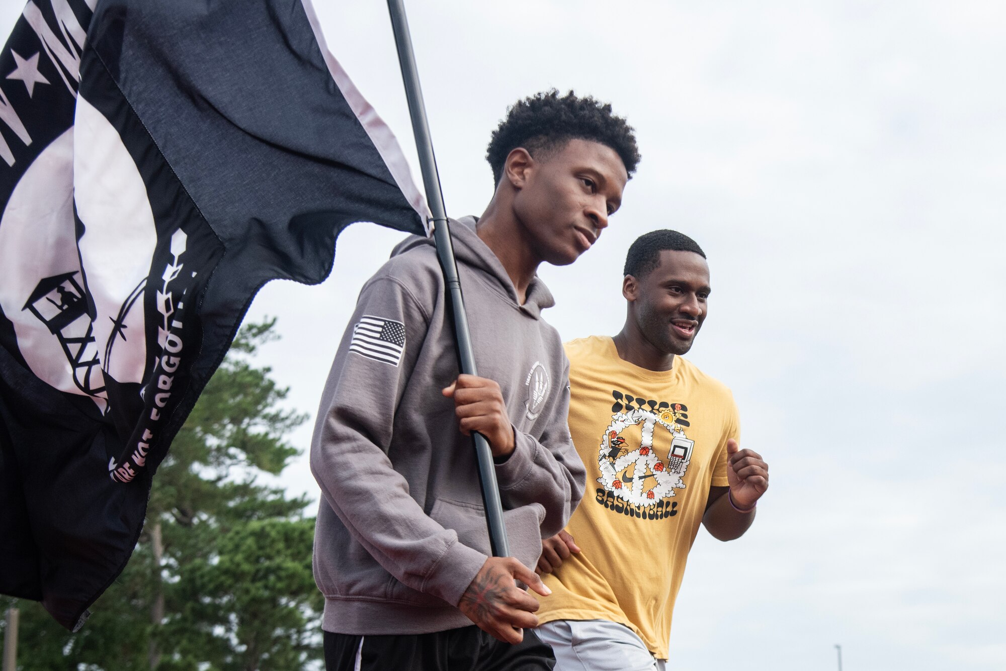 Airmen carry the POW/MIA Flag during a 24-hour vigil commemorating National POW/MIA Recognition Day.