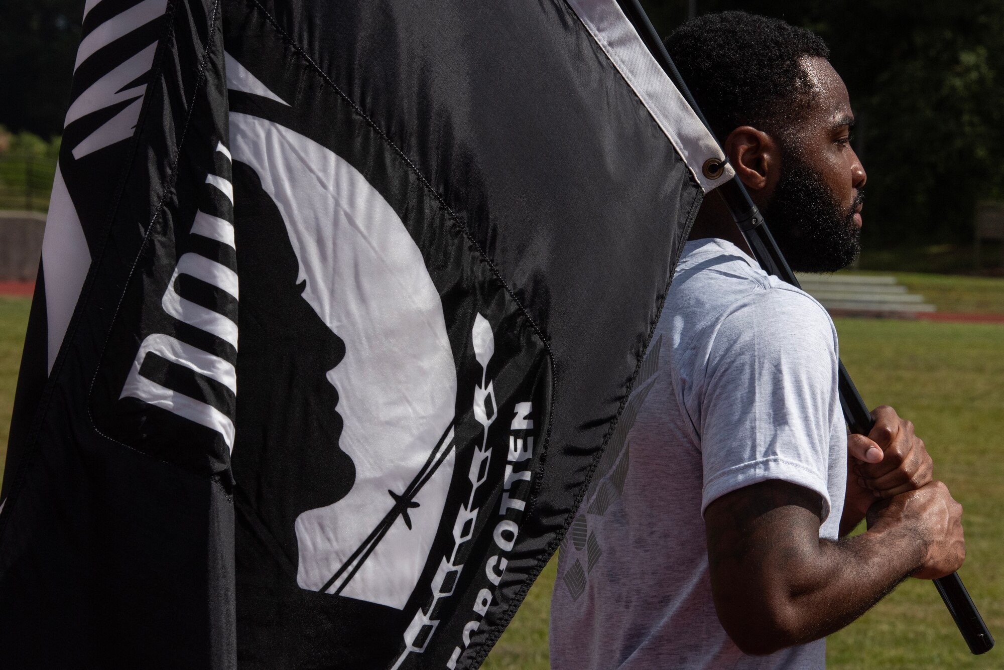 SSgt Tyvon Cooper, 4th MUNS, carries the POW/MIA Flag during a 24-hour vigil commemorating National POW/MIA Recognition Day.
