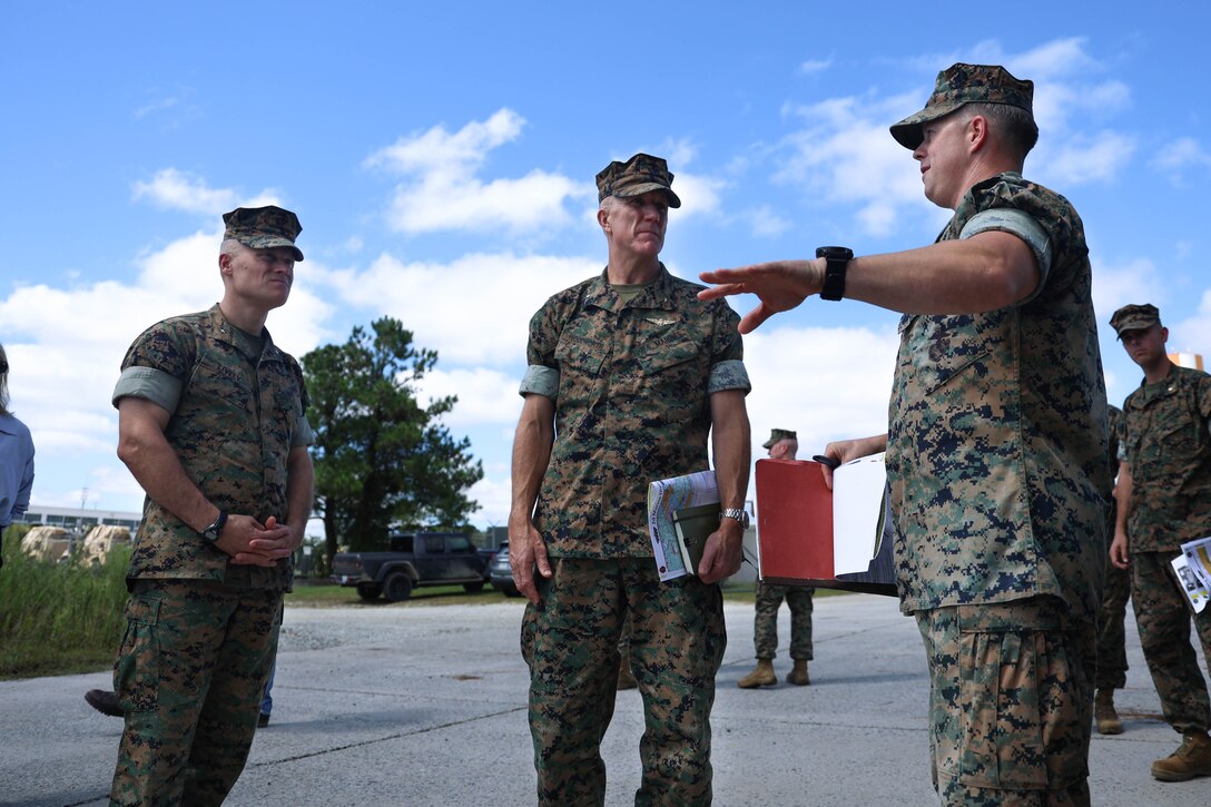 U.S. Marine Corps Brig. Gen. James Lively, left, assistant division commander, 2nd Marine Division, and Brig. Gen. Jason Woodworth, center, commanding general, Marine Corps Installations Command (MCICOM), are briefed by Lt. Col. William Goetz, right, battalion commander, 2nd Assault Amphibian Battalion (AABn) on Marine Corps Base (MCB) Camp Lejeune, North Carolina, Sept. 17, 2024. During the tour Woodworth met with Lively and 2nd AABn leaders during a tour of their facilities and training areas as well as post Hurricane Florence construction and regular military construction projects across MCB Camp Lejeune. (U.S. Marine Corps photo by Cpl. Zeta Johnson)