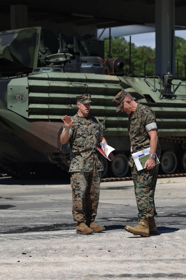 U.S. Marine Corps Lt. Col. William Goetz, left, battalion commander, 2nd Assault Amphibian Battalion (AABn), and Brig. Gen. Jason Woodworth, commanding general, Marine Corps Installations Command, talk in front of an amphibious assault vehicle during a tour of 2nd AABn on Marine Corps Base (MCB) Camp Lejeune, North Carolina, Sept. 17, 2024. During the tour Woodworth met with 2nd AABn leaders during a tour of their facilities and training areas as well as post Hurricane Florence construction and regular military construction projects across MCB Camp Lejeune. (U.S. Marine Corps photo by Cpl. Zeta Johnson)