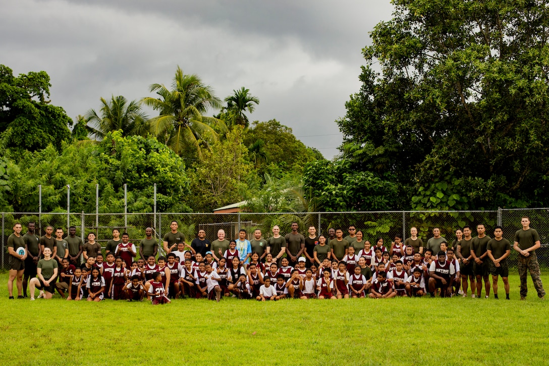 U.S. Marines and Sailors with Combat Logistics Battalion 13, Combat Logistics Regiment 17, 1st Marine Logistics Group and students of Meyuns Elementary School pose for a group photo during a sports community relations event at Koror, Palau, July 19, 2024. During Koa Moana’s deployment throughout the Indo-Pacific region, U.S. Marines and Sailors from I Marine Expeditionary Force work to strengthen alliances and partnerships with development of interoperable capabilities, combined operations, theater security cooperation, and capacity-building efforts. (U.S. Marine Corps photo by Sgt. Nello Miele)