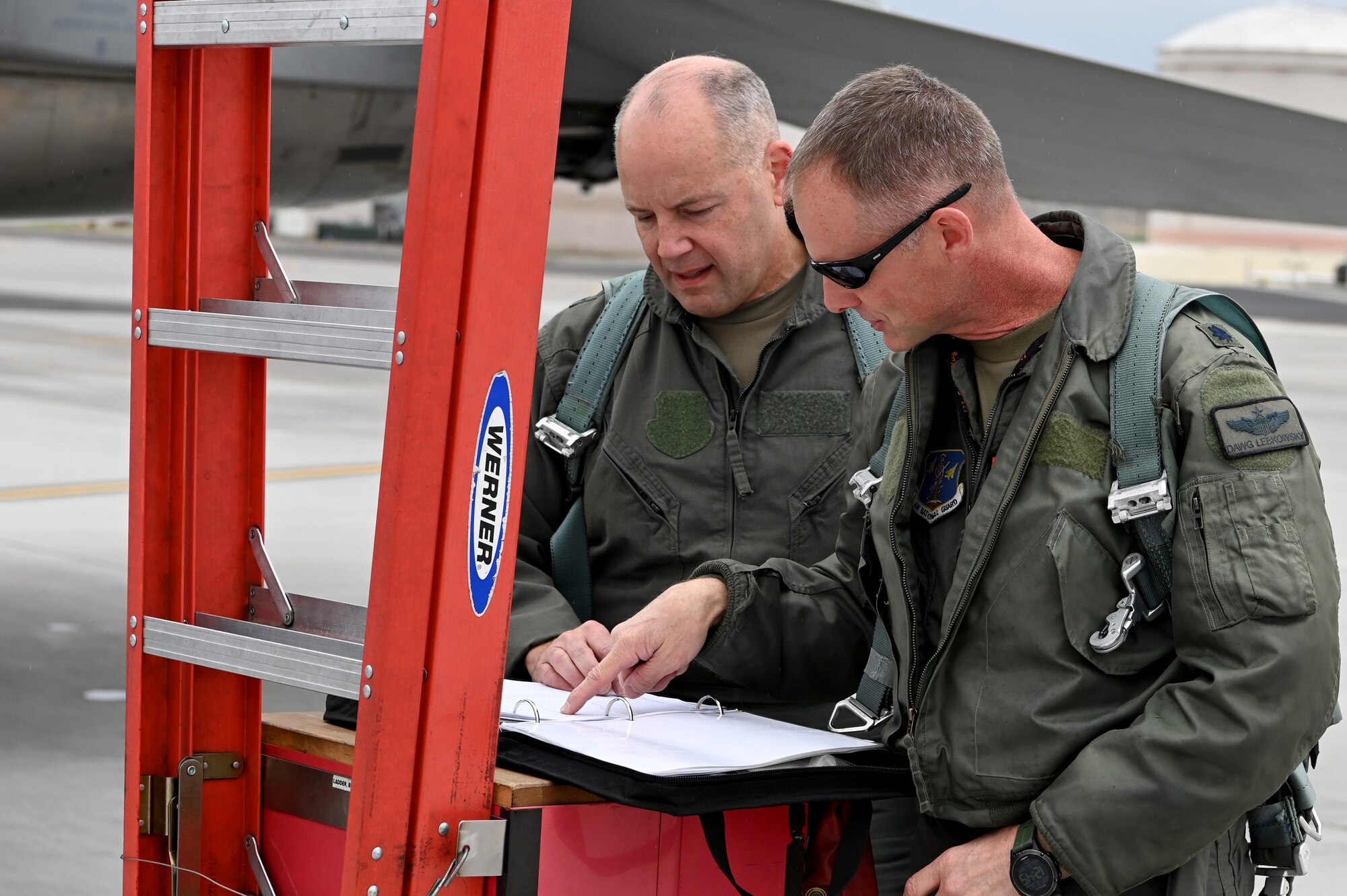 U.S. Air Force Maj. Gen. Duke Pirak, Deputy Director, Air National Guard, left, and Lt. Col. Quentin Lebkowsky, 173rd Fighter Wing F-15C instructor pilot, right, review the aircraft status paperwork before performing preflight ops checks.