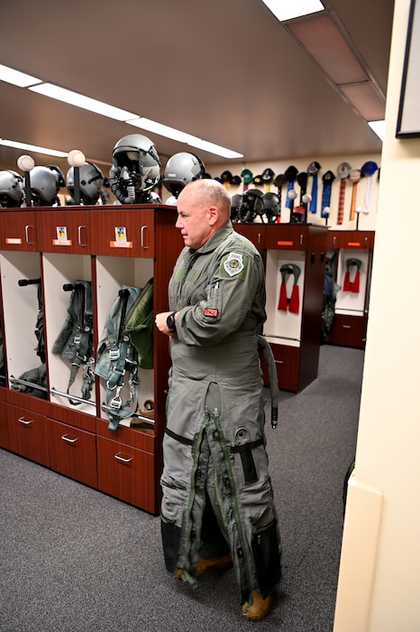 U.S. Air Force Maj. Gen. Duke Pirak, Deputy Director, Air National Guard, puts on his G-suit as he prepares to fly the F-15 Eagle.