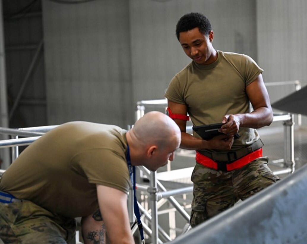 Two U.S. Air Force Airmen attached to the 37th Bomber Generation Squadron, do routine maintenance on a B-1B Lancer in support of exercise Raider Reach at Ellsworth Air Force Base, S.D., Sept. 17, 2024.