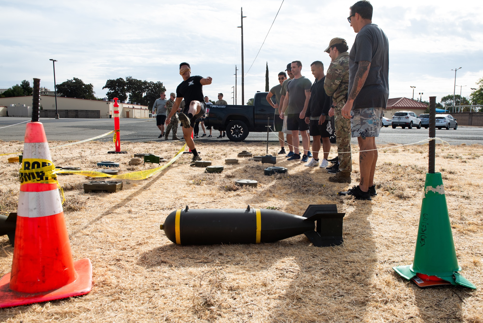 Airmen walks through simulated explosive course blindfolded.