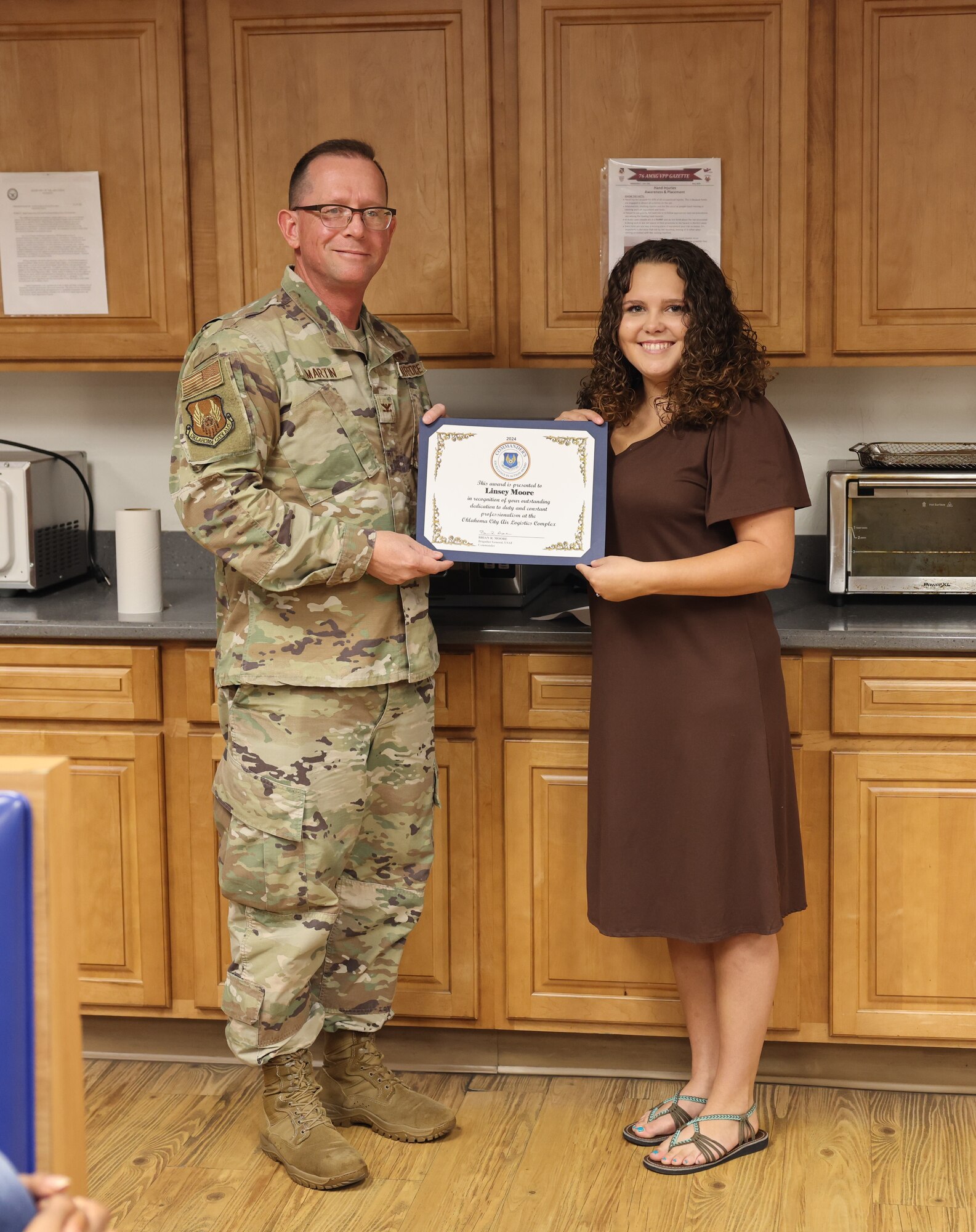 A man giving a woman an award