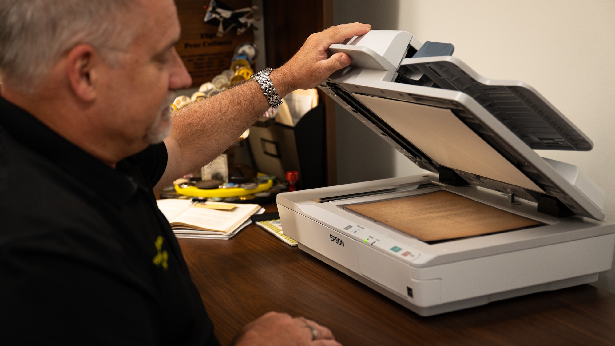 Peter Coffman, 325th Fighter Wing historian, digitally scans a document from World War II at Tyndall Air Force Base