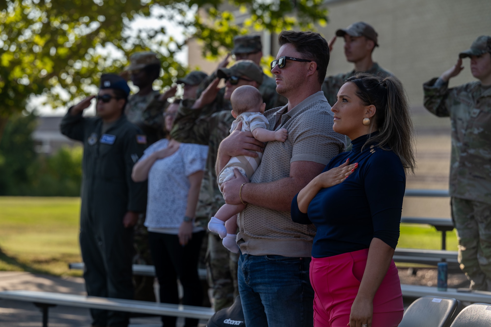 Spectators honor the U.S. flag during a POW/MIA wreath laying ceremony at McConnell Air Force Base, Kansas, Sept. 16, 2024. The wreath laying ceremony reflects commitment to finding prisoners of war actively missing and recognizes the sacrifices made by those service members and their families. (U.S. Air Force photo by Airman 1st Class Paula Arce)