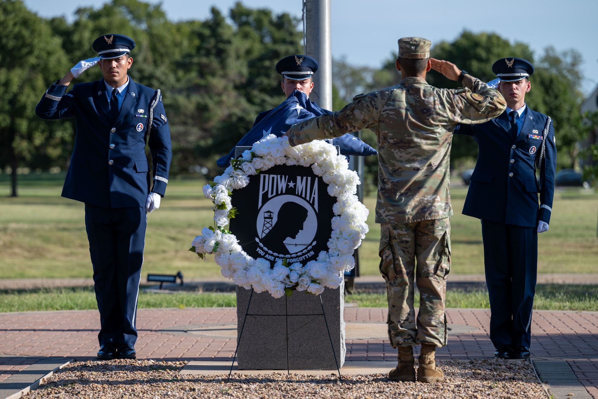 The 22nd Air Refueling Wing Honor Guard salutes the U.S. flag during the POW/MIA week opening ceremony at McConnell Air Force Base, Kansas, Sept. 16, 2024. The wreath laying ceremony reflects commitment to finding prisoners of war actively missing and recognizes the sacrifices made by those service members and their families. (U.S. Air Force photo by Airman 1st Class Paula Arce)