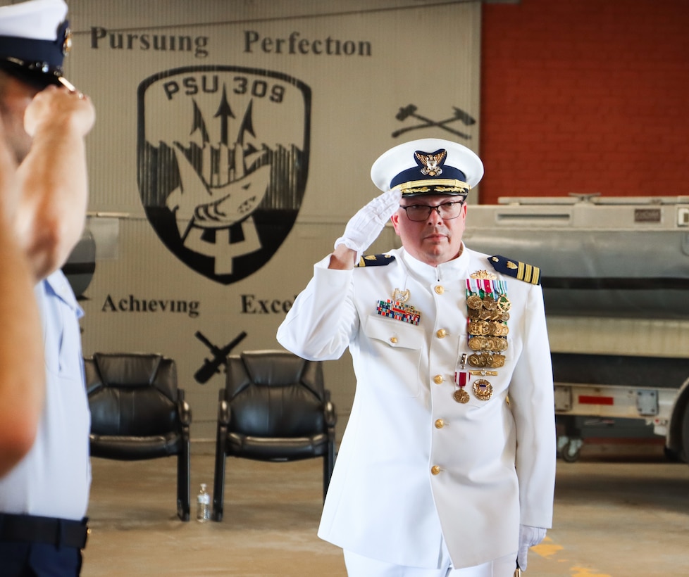 Cmdr. Todd A. Remusat, outgoing Coast Guard Port Security Unit 309 commanding officer, salutes service members as he departs the unit's change of command ceremony in Port Clinton. Ohio, Sept. 21, 2024. Remusat served as PSU 309’s commanding officer from June 2021 to September 2024 and led 150 personnel ensuring reserve unit readiness for worldwide or domestic deployments. (U.S. Coast Guard photo by Petty Officer 2nd Class Joshua Sanchez)