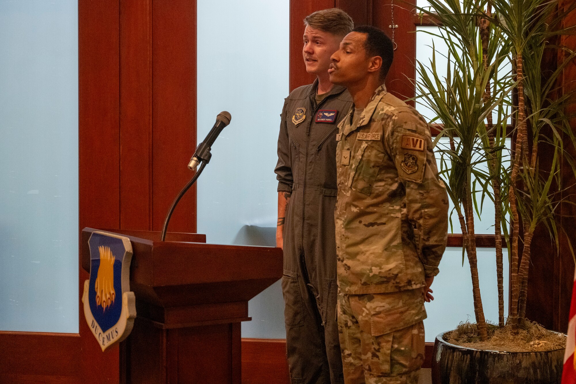 Senior Airman Robert Purnell, 349th Air Refueling Squadron unit deployment manager, and Airman 1st Class Eric Custodio, 22nd Aircraft Maintenance Squadron avionics technician, sing the national anthem during the POW/MIA Remembrance Week closing ceremony at McConnell Air Force Base, Kansas, Sept. 20, 2024. POW/MIA Remembrance week is held annually during the third week of September to honor more than 81,000 Americans still missing. (U.S. Air Force photo by Senior Airman Felicia Przydzial)