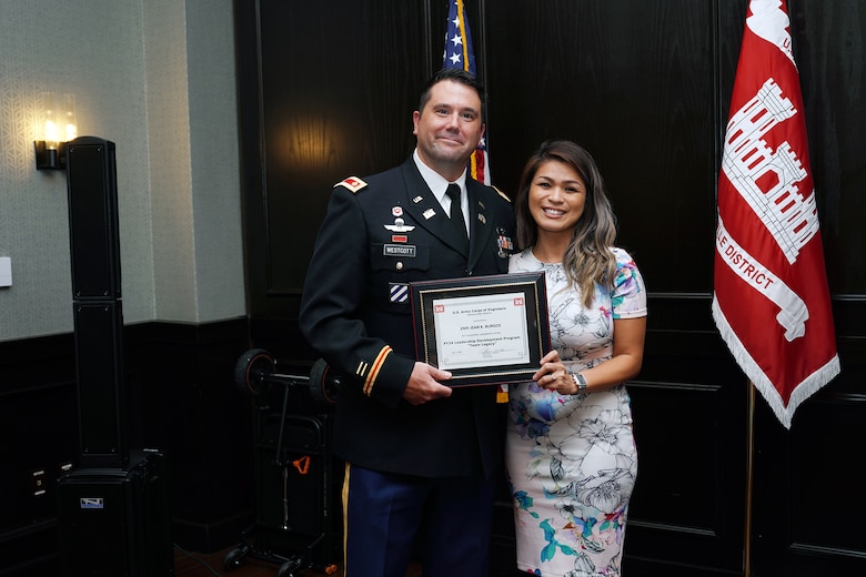 Maj. Matt Westcott Jacksonville District deputy commander presents Enri Jean (EJ) Burgos, a regulatory specialist her Leadership Development Program Course graduation certificate during a ceremony Sept. 12, 2024, at Maggiano's Little Italy in Jacksonville’s Town Center in Jacksonville, Fla. (USACE Photo by Mark Rankin)