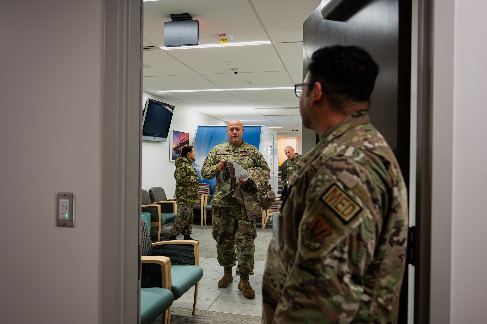 U.S. Air Force Staff Sgt. Richard Donnelly, 325th Operational Medical Readiness Squadron flight operational medical technician, greets Master Sgt. Stephan Price, 325th Operations Support Squadron radar approach control, during an appointment