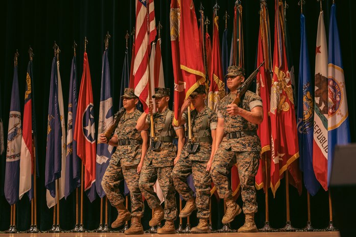 U.S. Marines with Quantico Ceremonial Platoon presents the colors during a change of command ceremony on Marine Corps Base Quantico, Virginia, August 9, 2024. TECOM leads Marine Corps Training and Education from individual entry-level training, professional military education and continuous professional development, through unit, collective, and service-level training in order to produce warfighters for the Fleet Marine Force to build and sustain combat readiness. (U.S. Marine Corps photo by Lance Cpl. Ethan Miller)