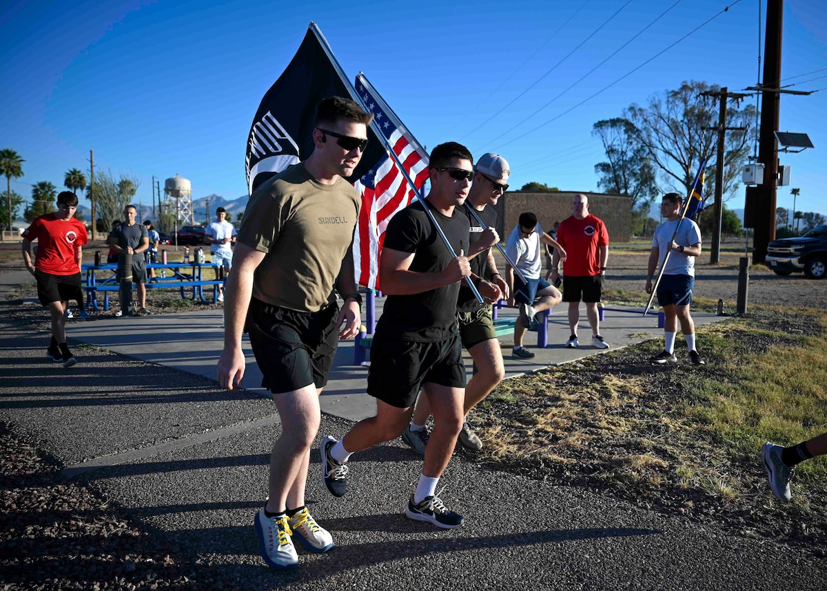 People carry flags while running.