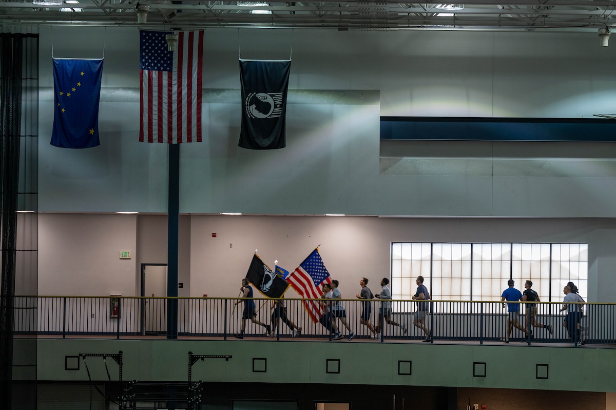 U.S. Air Force Airmen, assigned to the 354th Maintenance Group, run around the Baker Field House indoor track during the 24 hour POW/MIA run at Eielson Air Force Base, Alaska, Sept. 19, 2024.