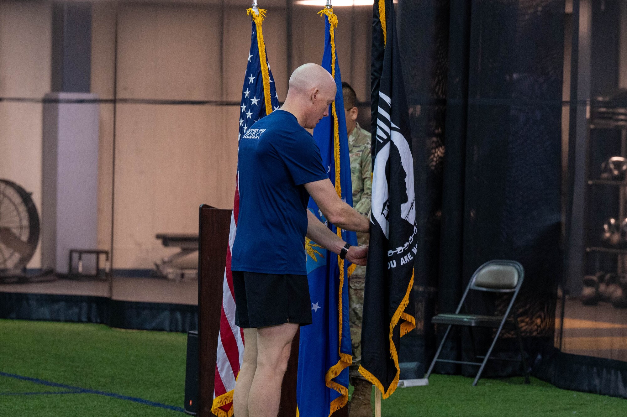 U.S. Air Force Senior Master Sgt. Brian Medley, 354th Civil Engineering Squadron first sergeant, presents the POW/MIA flag at the conclusion of the 24 hour POW/MIA run at Eielson Air Force Base, Alaska, Sept. 20, 2024.