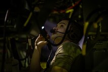 Airman inspects engine