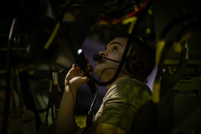 Airman inspects engine