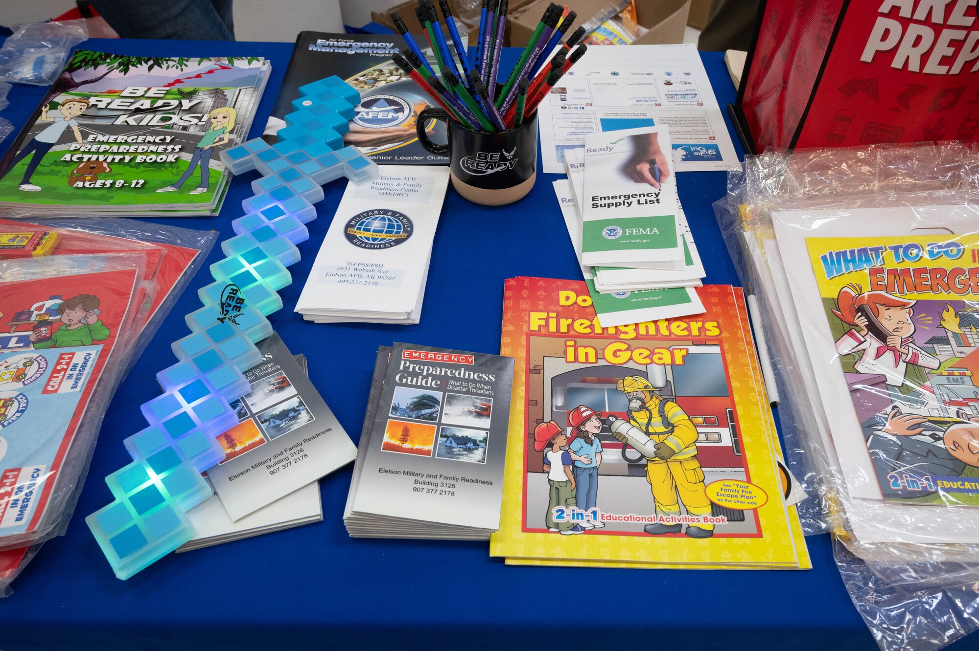 Coloring books, magazines and pamphlets, designed to aid in staying prepared for crises, are displayed on a Military & Family Readiness Center booth at Eielson Air Force Base, Alaska, Sept. 19, 2024.