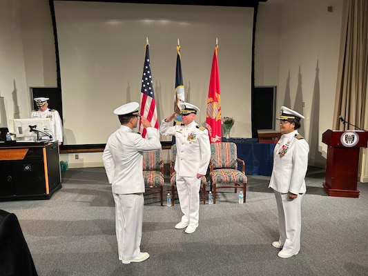 The Navy Bloodborne Infection Management Center (NBIMC) held a change of charge ceremony on August 23, 2024. During the ceremony Cmdr. Marshall Hoffman, the oncoming officer in charge of NBIMC, salutes Capt. Marion Gregg, commander, Navy and Marine Corps Force Health Protection Command, and director, Defense Center for Public Health Portsmouth, center, presiding officer over the ceremony which was held at Naval Support Activity Bethesda, Maryland. Great strides were made in modernizing the readiness tool of HMS under Teneza-Mora’s tenure and it looks to be continued and improved upon with the arrival of Cmdr. Hoffman. “Modern HIV management allows people to live normal lives, and I am proud that the military recognizes this and allows service members with HIV to serve their country to the maximal extent possible,” said Hoffman. (Navy courtesy photo by Mrs. Ashley Hoffman)