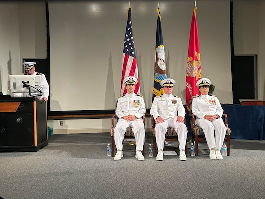 The Navy Bloodborne Infection Management Center (NBIMC) held a change of command ceremony on August 23, 2024. During the ceremony Capt. Nimfa Teneza-Mora, right, relinquishes her duties as the officer in charge of NBIMC and transfers them to oncoming officer in charge of NBIMC Cmdr. Marshall Hoffman, left. Capt. Marion Gregg, commander, Navy and Marine Corps Force Health Protection Command, and director, Defense Center for Public Health Portsmouth, center, presiding officer over the ceremony which was held at Naval Support Activity Bethesda, Maryland. Under Teneza-Mora leadership, the NBIMC maximized support for service members with positive test results, facilitated their expeditious notification and linkage to medical care and treatment, promoting these service members’ health, wellness, and expeditious return to full duty. (Navy courtesy photo by Mrs. Ashley Hoffman)