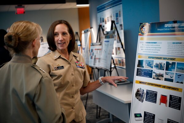 BETHESDA, Md. (Sept. 11, 2024) Rear Adm. Pam Miller (left), the Medical Officer (TMO) of the Marine Corps, engages with Naval Medical Research Command (NMRC) staff during a Health Services Operational Advisory Group (HSOAG) meeting. Marine Corps Health Services, led by TMO, advises the Commandant and Marines Headquarters staff on all healthcare matters. TMO serves as the functional expert in working with the appropriate Headquarters agencies for determining medical requirements and makes recommendations on all medical matters relevant to supporting the Marine Corps. NMRC is engaged in a broad spectrum of medical research, from basic science in the laboratory to field studies in austere and remote areas of the world to investigations in operational environments. In support of the Navy, Marine Corps and joint U.S. warfighters, NMRC researchers study infectious diseases, biological warfare detection and defense, combat casualty care, environmental health concerns, aerospace and undersea medicine, medical modeling, simulation, operational mission support, epidemiology and behavioral sciences. (U.S. Navy photo by Tommy Lamkin/Released)