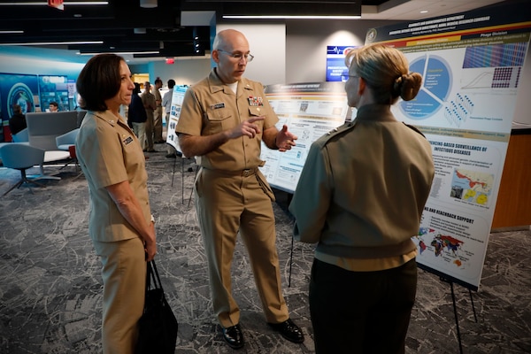 BETHESDA, Md. (Sept. 11, 2024) Rear Adm. Pam Miller (right), the Medical Officer (TMO) of the Marine Corps, engages with Naval Medical Research Command (NMRC) staff during a Health Services Operational Advisory Group (HSOAG) meeting. Marine Corps Health Services, led by TMO, advises the Commandant and Marines Headquarters staff on all healthcare matters. TMO serves as the functional expert in working with the appropriate Headquarters agencies for determining medical requirements and makes recommendations on all medical matters relevant to supporting the Marine Corps. NMRC is engaged in a broad spectrum of medical research, from basic science in the laboratory to field studies in austere and remote areas of the world to investigations in operational environments. In support of the Navy, Marine Corps and joint U.S. warfighters, NMRC researchers study infectious diseases, biological warfare detection and defense, combat casualty care, environmental health concerns, aerospace and undersea medicine, medical modeling, simulation, operational mission support, epidemiology and behavioral sciences. (U.S. Navy photo by Tommy Lamkin/Released)