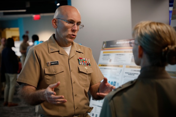 BETHESDA, Md. (Sept. 11, 2024) Rear Adm. Pam Miller, the Medical Officer (TMO) of the Marine Corps, engages with Naval Medical Research Command (NMRC) staff during a Health Services Operational Advisory Group (HSOAG) meeting. Marine Corps Health Services, led by TMO, advises the Commandant and Marines Headquarters staff on all healthcare matters. TMO serves as the functional expert in working with the appropriate Headquarters agencies for determining medical requirements and makes recommendations on all medical matters relevant to supporting the Marine Corps. NMRC is engaged in a broad spectrum of medical research, from basic science in the laboratory to field studies in austere and remote areas of the world to investigations in operational environments. In support of the Navy, Marine Corps and joint U.S. warfighters, NMRC researchers study infectious diseases, biological warfare detection and defense, combat casualty care, environmental health concerns, aerospace and undersea medicine, medical modeling, simulation, operational mission support, epidemiology and behavioral sciences. (U.S. Navy photo by Tommy Lamkin/Released)