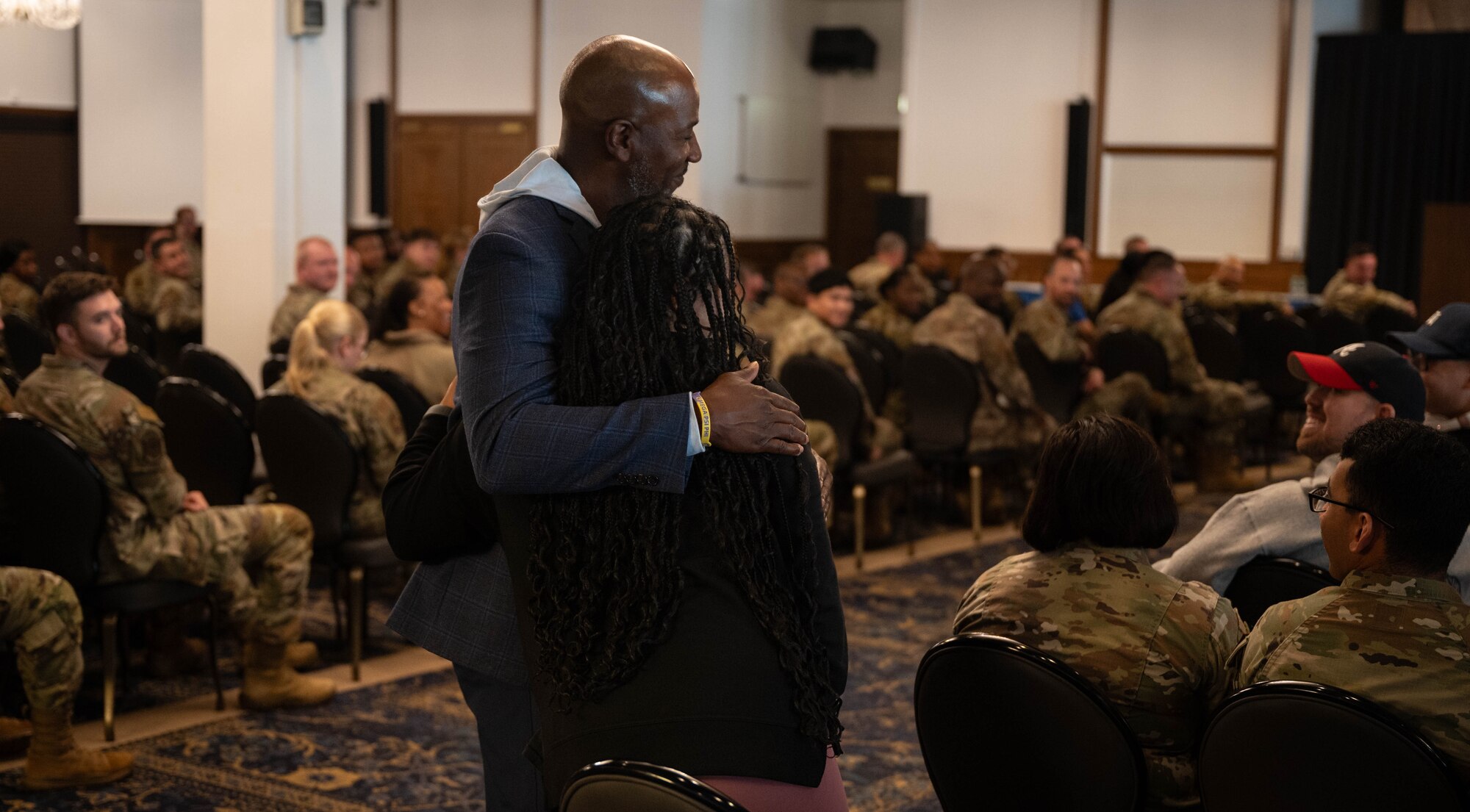 Retired U.S. Air Force Chief Master Sergeant of the Air Force #18, Kaleth O. Wright, hugs a participant of a Q&A session at Ramstein Air Base, Germany, Sept. 20, 2024. During his visit to the Kaiserslautern Military Community, Wright held a Q&A session with Airmen, sharing insights from his personal life and military career. (U.S. Air Force Photo by Senior Airman Jared Lovett)