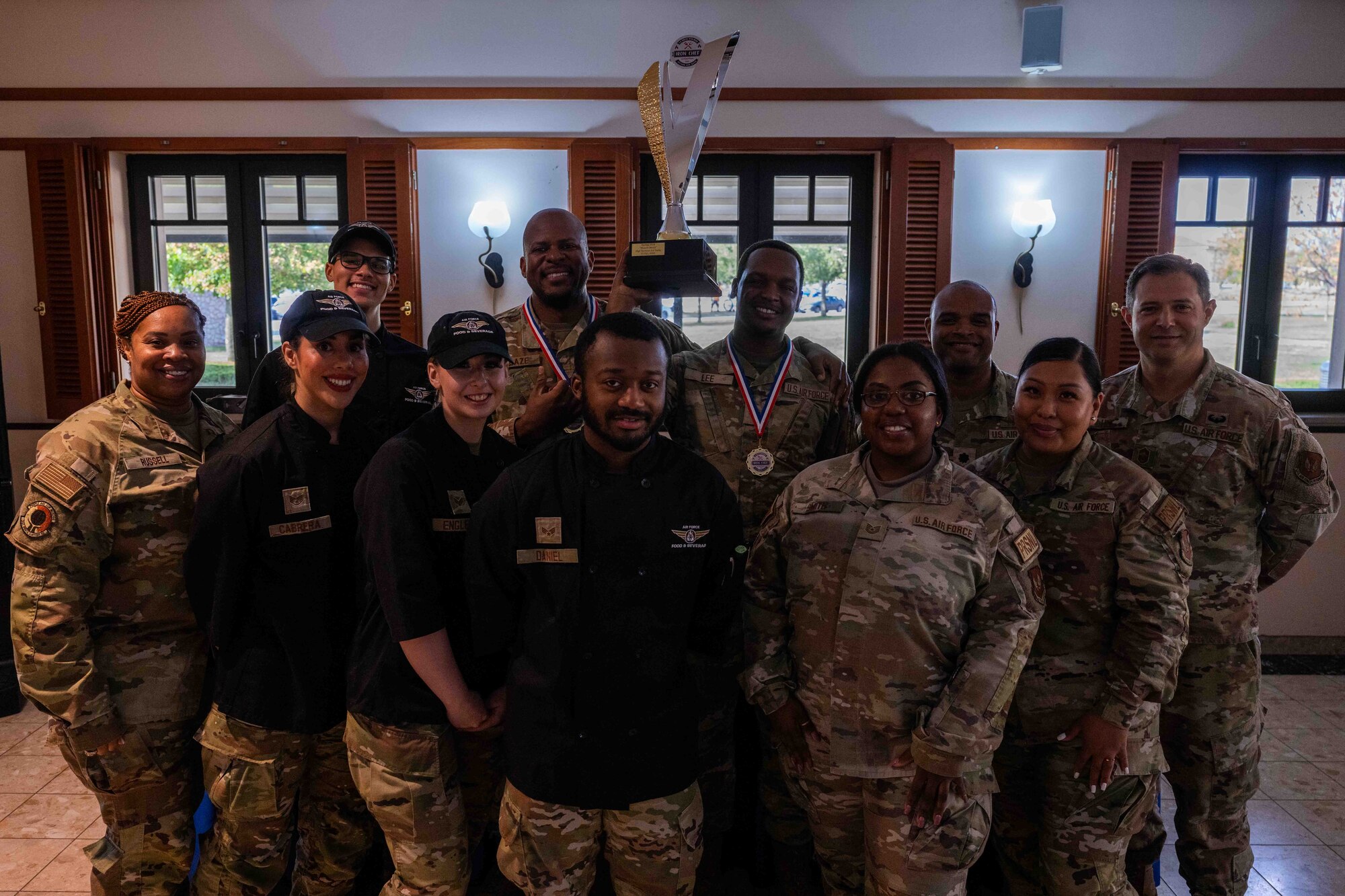 Competitors and judges for the Iron Chef competition take a group photo.