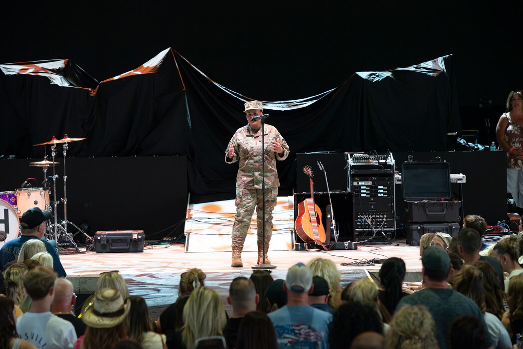 Air Force Materiel Command deputy commander standing on stage speaking to the crowd.