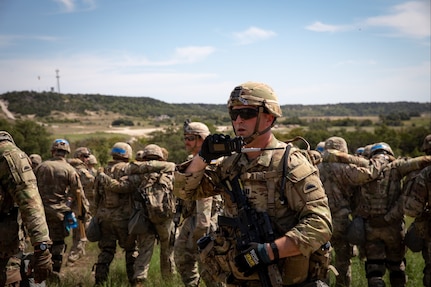 U.S. Army Capt. Joe Kaufman, 2nd Battalion, 162nd Infantry Regiment, Oregon Army National Guard, communicates radio commands during training at Fort Cavazos, Texas, Sept. 14, 2024. The Soldiers are preparing to support NATO-led Kosovo Forces, also known as KFOR, in a peacekeeping mission.