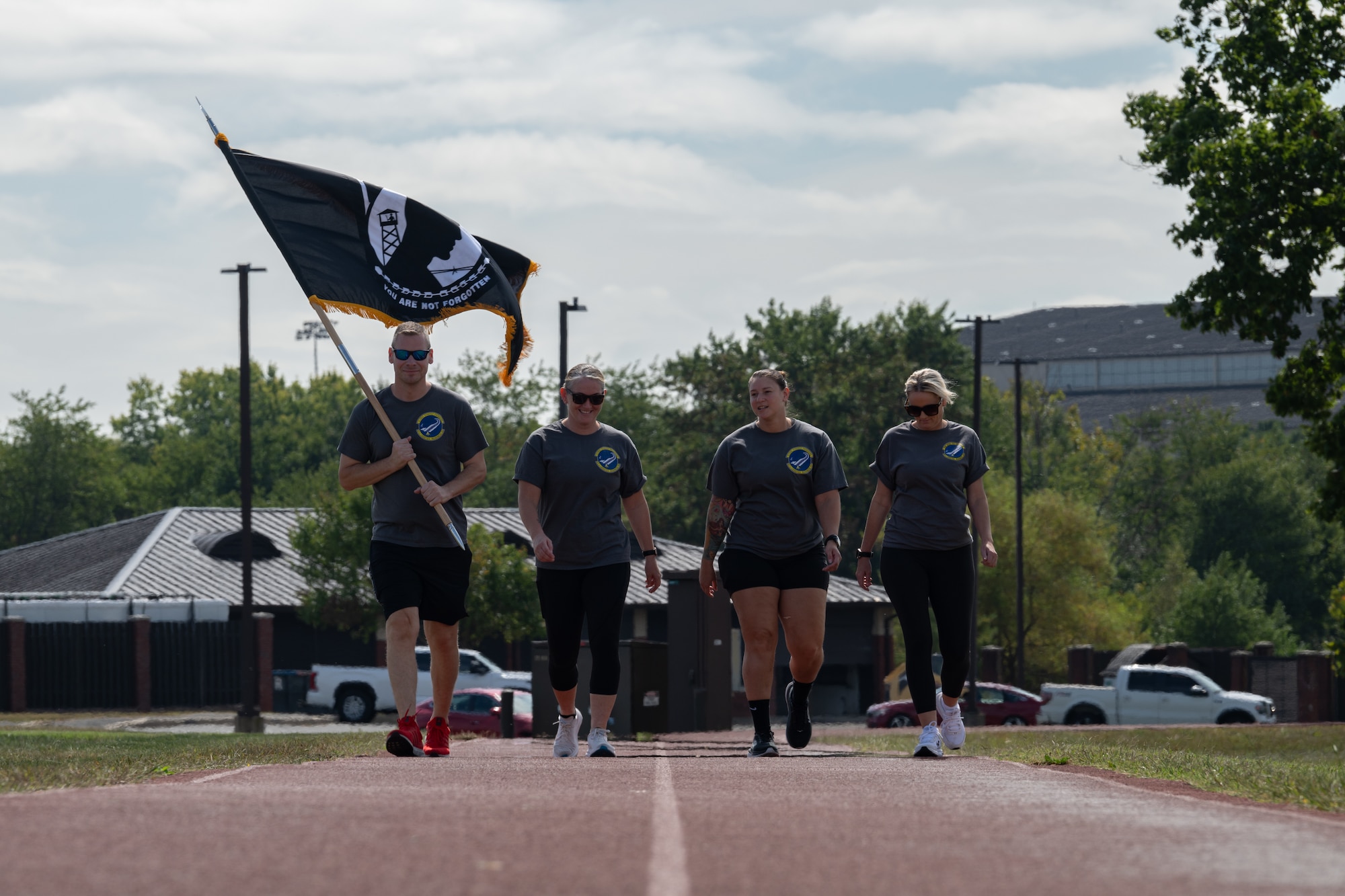 Members assigned to the 87th Logistics Readiness Squadron walk with a Prisoner of War and Missing in Action flag during a You Matter Day event at Joint Base McGuire-Dix-Lakehurst, N.J., Sept. 19, 2024. The day kicked off with opening remarks from U.S. Army Col. Bryan Dunker, U.S. Army Support Activity commander, followed by a screening of the documentary, “PTSD: The Walking Wounded,” and field activities. (U.S. Air Force photo by Senior Airman Aidan Thompson)
