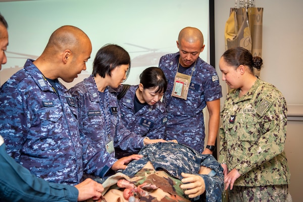 Naval Medical Center Portsmouth (NMCP) staff hosted medical personnel from ships that are part of the Japanese Training Squadron’s Overseas Training Cruise, Sept. 23. An orientation tour and briefs at various locations in the medical center were given to the Japanese medical sailors and officers from the Japanese Maritime Self-Defense Force (JMSDF) JS Kashima and JS Shimakaze. The group visited the medical center’s Healthcare Simulation and Bioskills Training Center (SIM Center), the Emergency Department, Surgical suites, and received briefs on telemedicine.