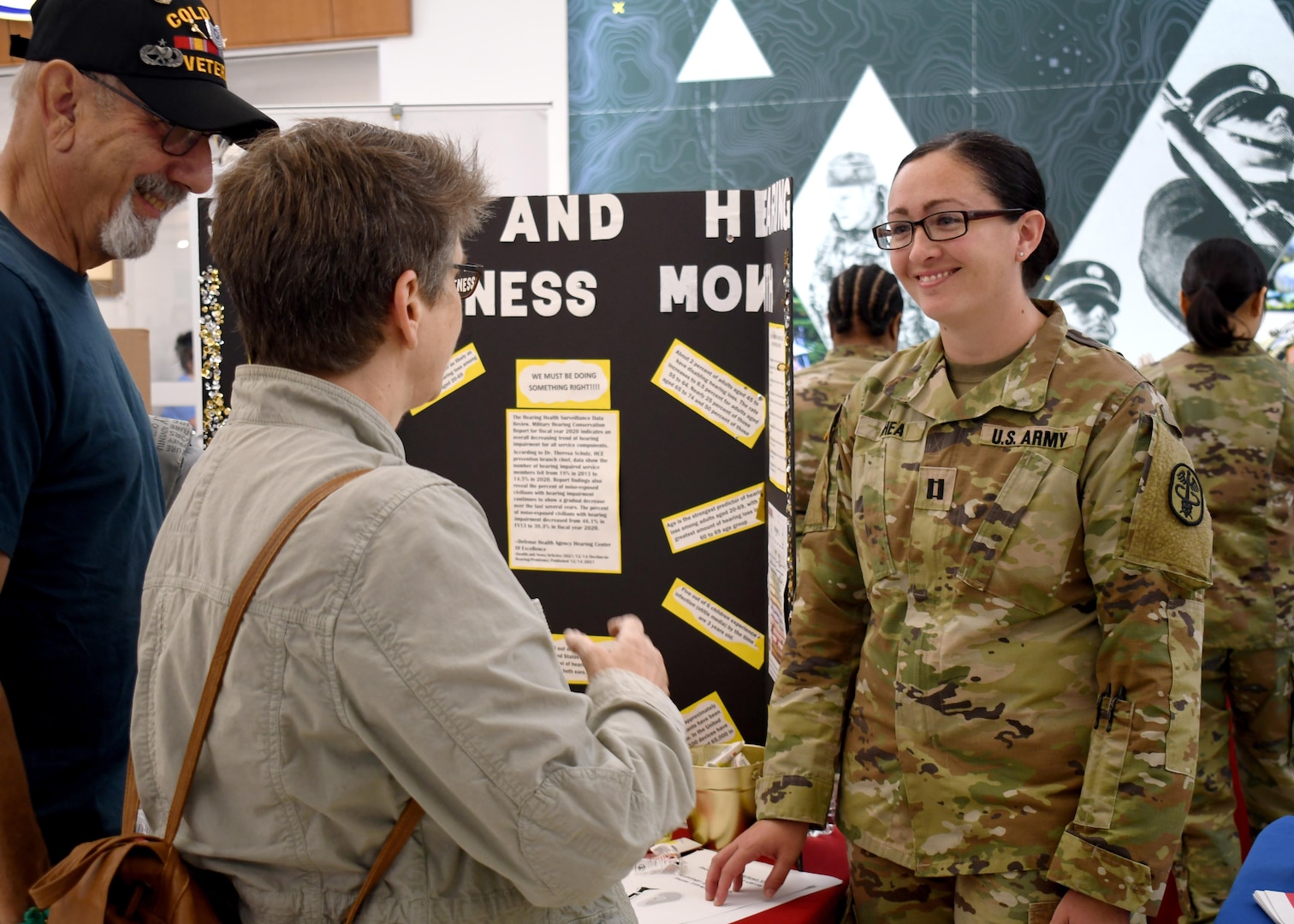 Capt. Katherine A. Rhea, the U.S. Army Medical Department Activity – Fort Drum chief of audiology, speaks to a military retiree and spouse about hearing conservation during the Fort Drum Retiree Appreciation Day at Fort Drum, N.Y., Sept. 21, 2024.