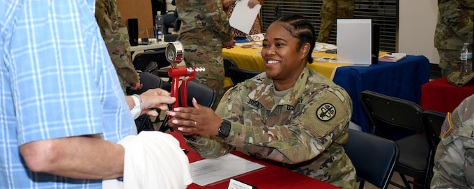 Sgt. Ashtin C. Josey, an occupational therapy specialist with the U.S. Army Medical Department Activity – Fort Drum, tests a military retiree’s grip strength during the Fort Drum Retiree Appreciation Day at Fort Drum, N.Y., Sept. 21, 2024.