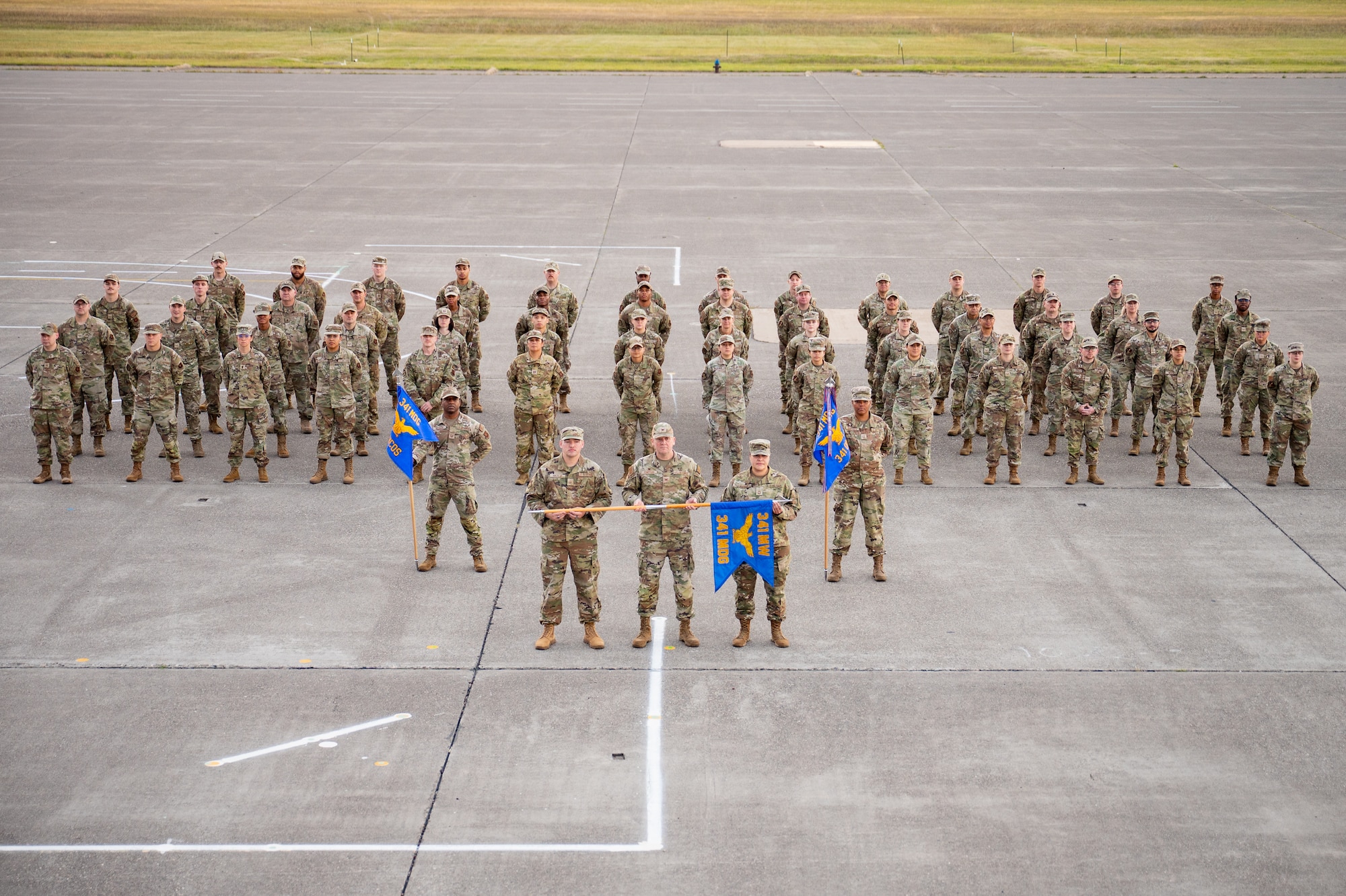A group of uniformed personnel stand together for a photo.