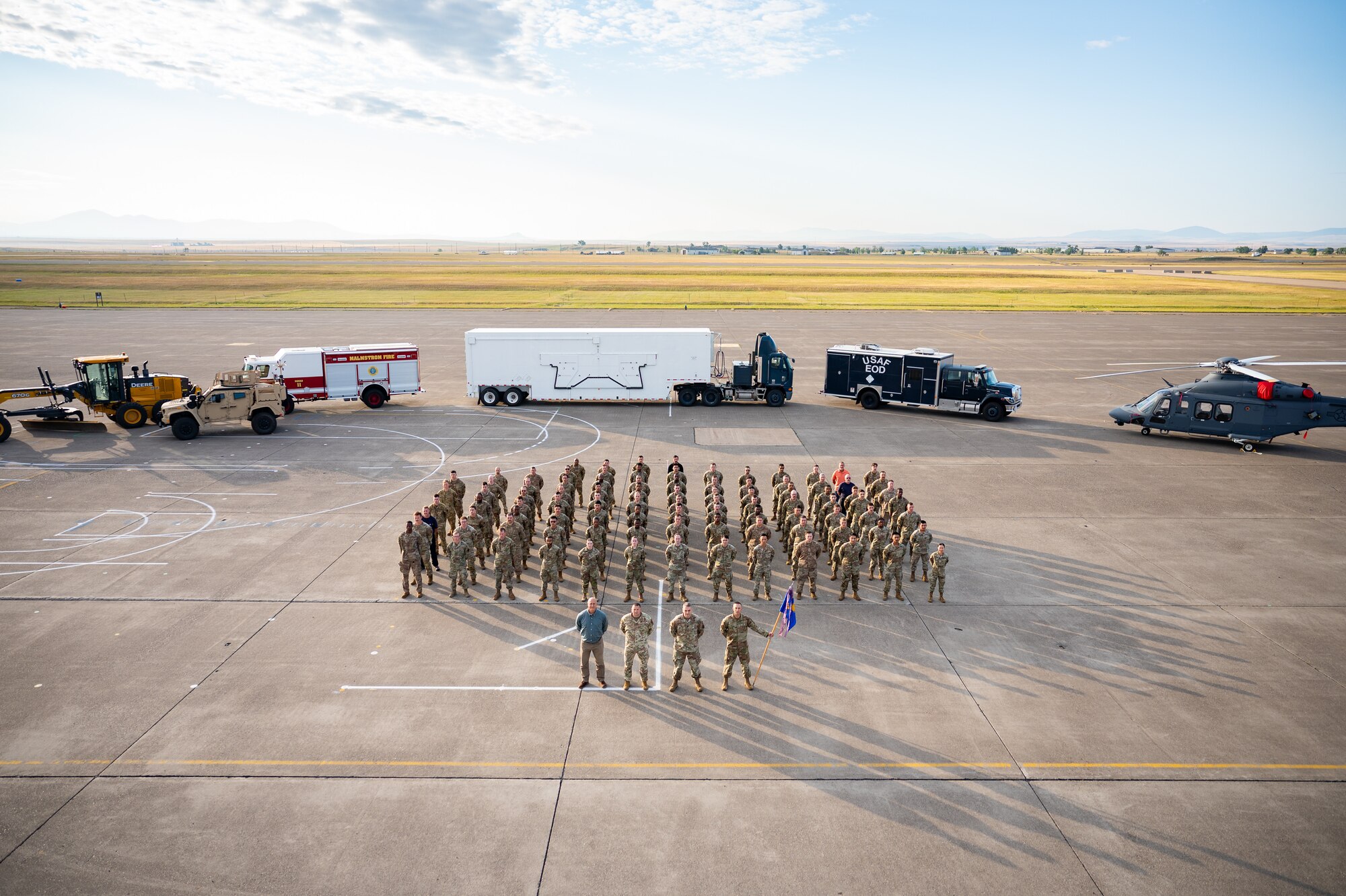 A group of uniformed personnel stand together for a photo.