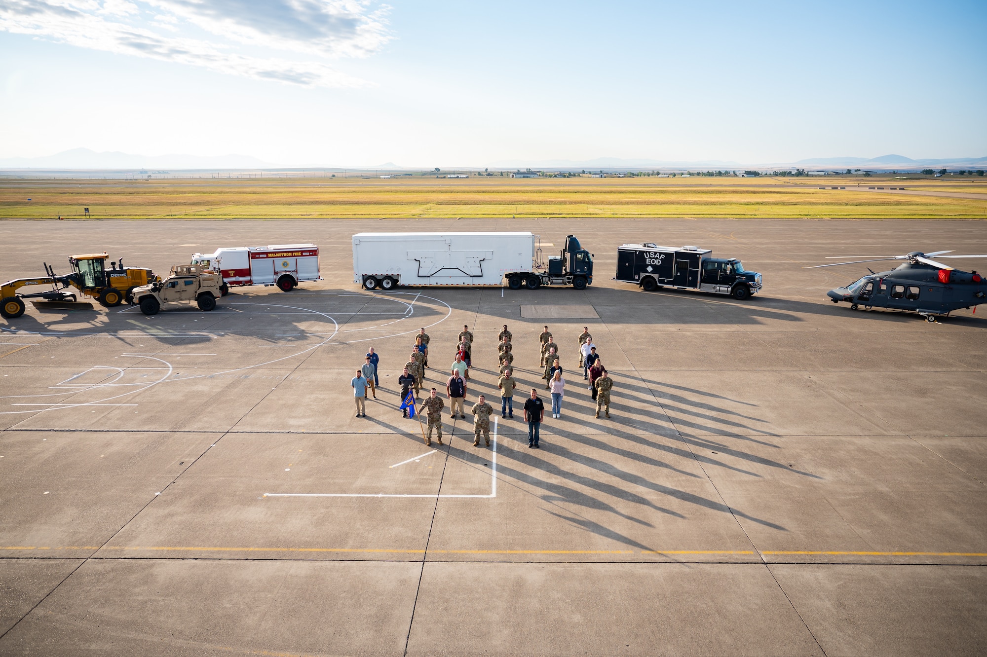 A group of uniformed personnel stand together for a photo.