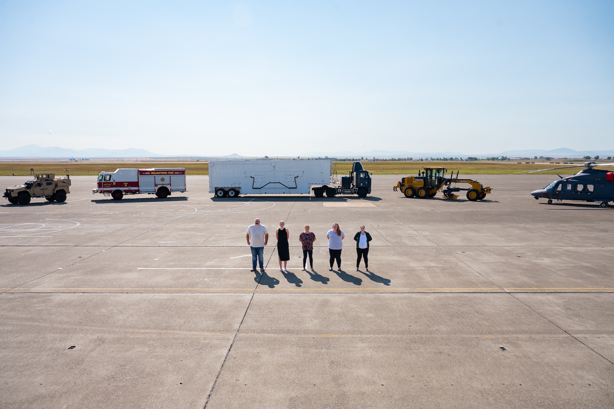 A group of uniformed personnel stand together for a photo.