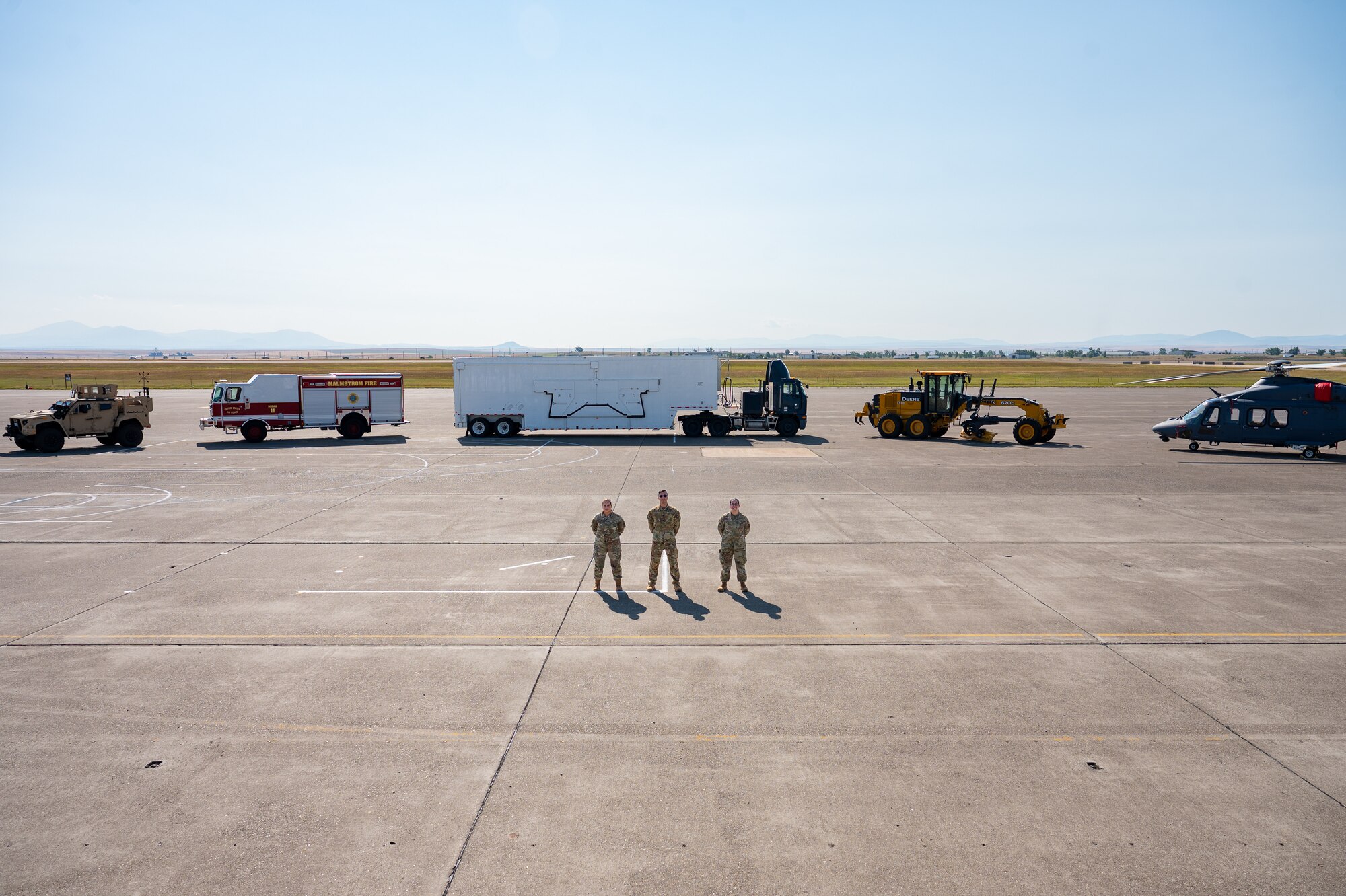 A group of uniformed personnel stand together for a photo.