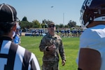 A Space Launch Delta 30 commander, flips a SLD 30 command coin to kick-off the 21st Annual Military Appreciation game at Alan Hancock College in Santa Maria, Calif.