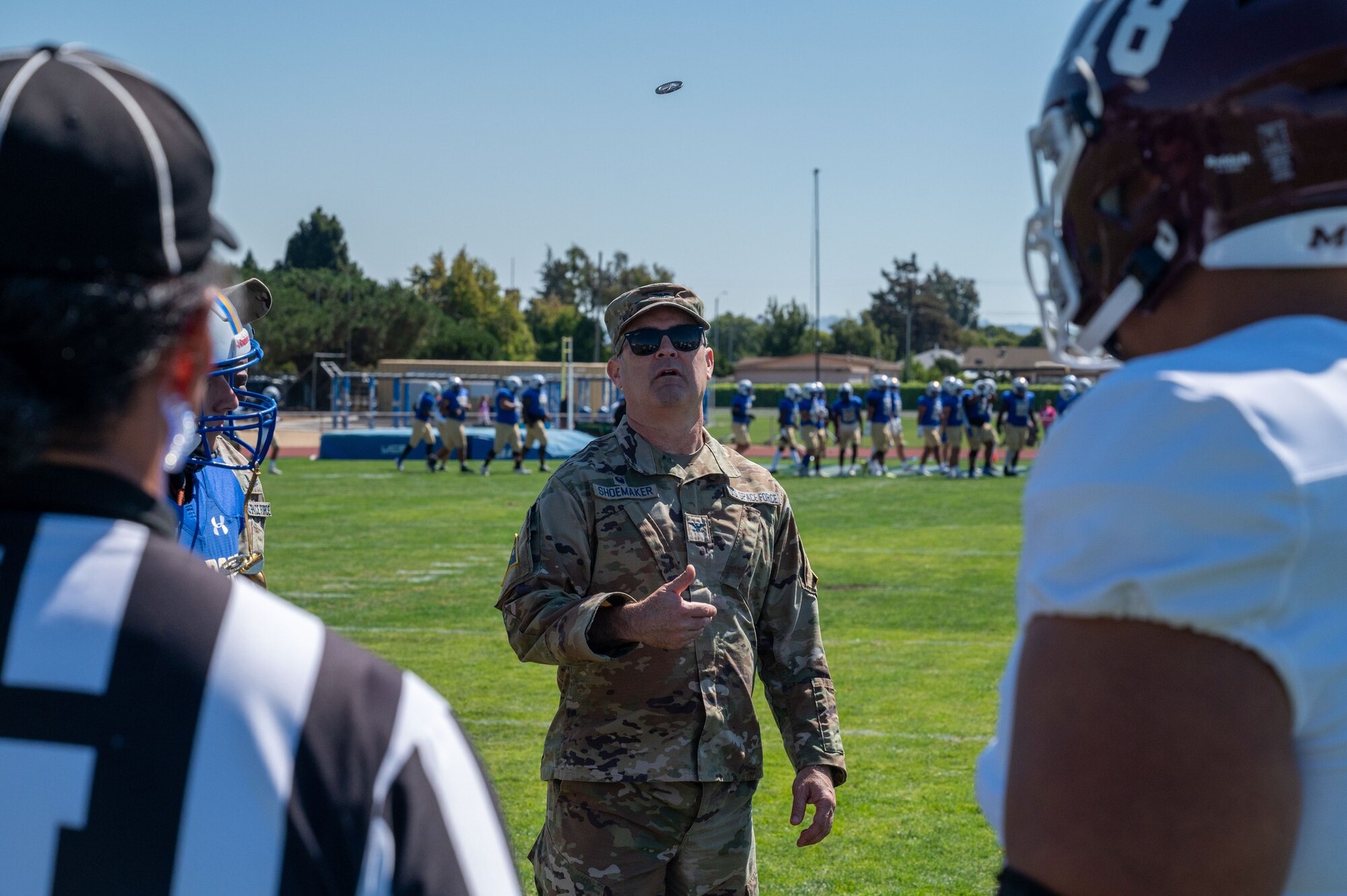 A Space Launch Delta 30 commander, flips a SLD 30 command coin to kick-off the 21st Annual Military Appreciation game at Alan Hancock College in Santa Maria, Calif.